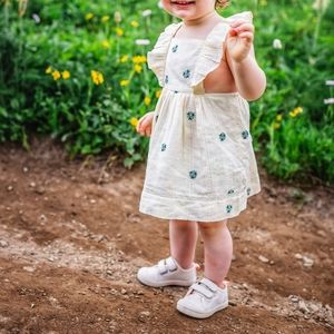 White dress with blue stiched flower